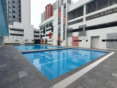 a large swimming pool in the middle of a building at Ipoh Modern Skyline & Mountain View Suite in Ipoh