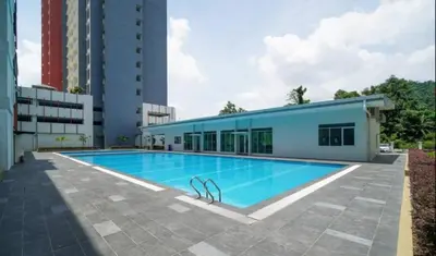 a swimming pool in front of a building at Ipoh Modern Skyline & Mountain View Suite in Ipoh