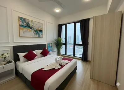 a bedroom with a large bed with red pillows at High floor Seaview 2BR Jazz Suite Bathtub &Sauna in Tanjong Tokong
