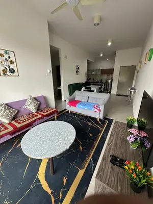 a living room with a table and a couch at Barrington Square Aleysha Homestay Night Market in Brinchang