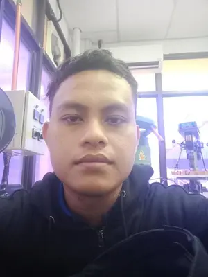 a young man is looking at the camera at Kedah in Padang Serai