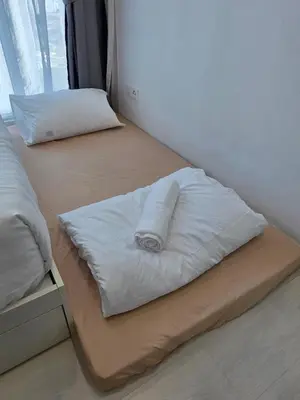 two beds with white pillows on them in a room at Pico City Suite #1BR in George Town