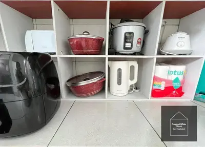 a kitchen shelf with pots and pans and a toaster at Zafirah Ipoh Homestay Musllim Only in Ipoh