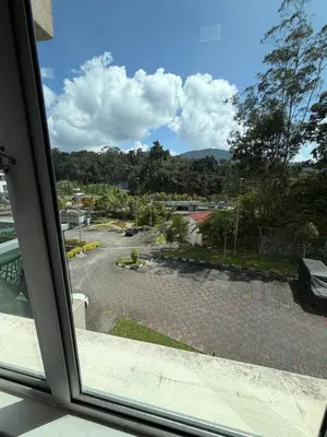 a view of a parking lot from a window at AYAAN ELITE HOME at Quintet Apartment with free parking & Ps4 Gaming and Netflix in Tanah Rata
