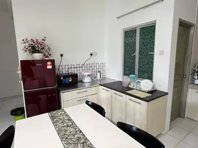 a kitchen with a refrigerator and a table with chairs at AYAAN ELITE HOME at Quintet Apartment with free parking & Ps4 Gaming and Netflix in Tanah Rata