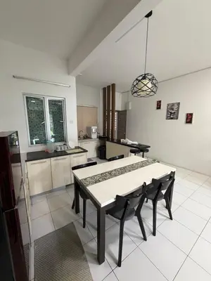 a kitchen with a table and chairs in a room at AYAAN ELITE HOME at Quintet Apartment with free parking & Ps4 Gaming and Netflix in Tanah Rata