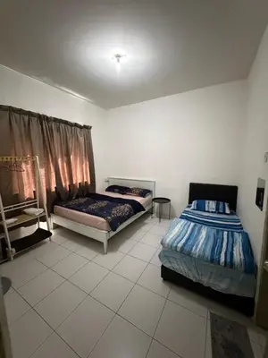 a bedroom with two beds and a window at AYAAN ELITE HOME at Quintet Apartment with free parking & Ps4 Gaming and Netflix in Tanah Rata