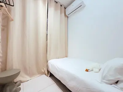 a small bedroom with a bed with a teddy bear on it at Urban Seaview, City view, New 3BR 6pax, Jelutong in George Town