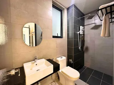 a bathroom with a sink and a toilet and a mirror at Urban Seaview, City view, New 3BR 6pax, Jelutong in George Town