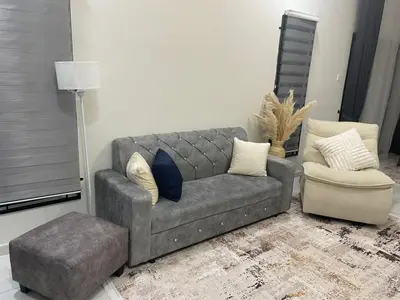 a living room with a couch and a chair at Nadine Homestay in Sungai Petani