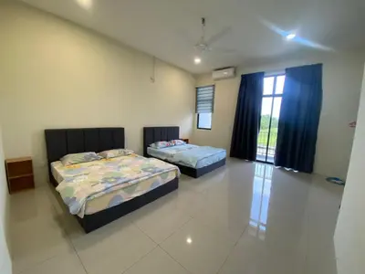 a bedroom with two beds and a window at 96 HomeStay Sungai Besar in Sungai Besar