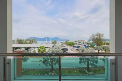a view of a parking lot from a window at Marina Island Lumut 3 Bedroom Holiday Apartment in Lumut