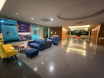 a lobby with couches and chairs in a building at IRONMAN HomeStay in Lumut