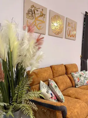 a living room with a brown couch and some pillows at KAYA HOMESTAY SRI IORa 2 in Sungai Petani
