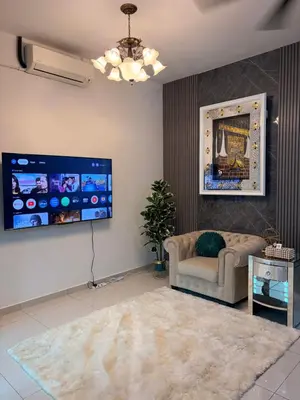 a living room with a couch and a flat screen tv at KAYA HOMESTAY SRI IORa 2 in Sungai Petani