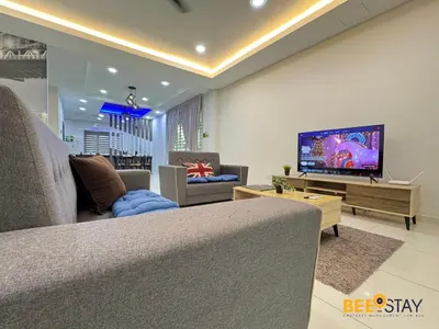 a living room with a couch and a flat screen tv at Taiping City Centre Landed Corner Lot for 12 Pax in Taiping