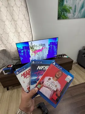 a person is holding up a video game controller at AYAAN ATRIUM Homestay with PS4 GAMING and Snookers in Tanah Rata