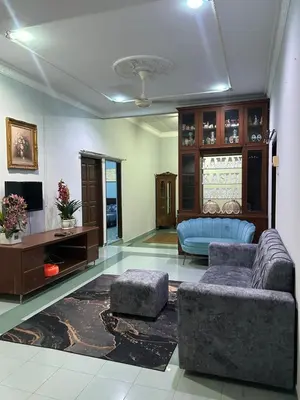 a living room with a couch and a tv at Homestay Laman Kasih Mama in Seri Manjung