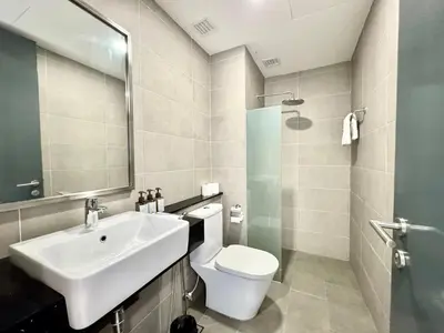 a bathroom with a white toilet and a sink at French Vintage Luxury 2BR Suites at Georgetown in George Town