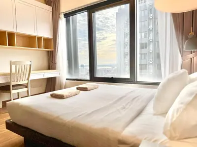 a bedroom with a large bed with two towels on it at French Vintage Luxury 2BR Suites at Georgetown in George Town