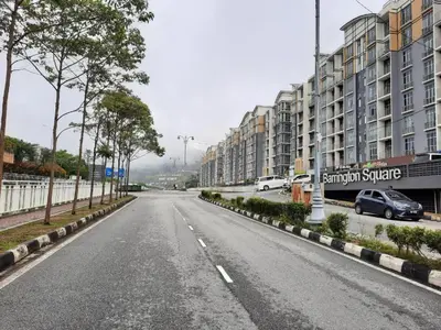an empty street in a city with buildings at Barrington Square Apartment Pasar Malam in Brinchang