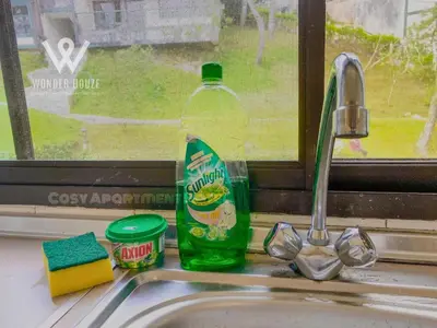 a bottle of cleaning detergent sitting on a kitchen sink at Cozy Highlands Escape at Copthorne Cameron Highlands in Tanah Rata