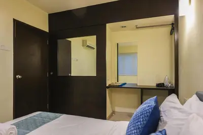 a hotel room with a bed and a mirror at Marina Island Lumut Homestay in Lumut