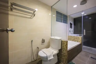a bathroom with a toilet and a sink and a shower at Marina Island Lumut Homestay in Lumut
