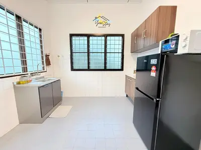 a kitchen with a refrigerator and a sink at CozyKota8Pax 4MinsToJonker in Gua Sai