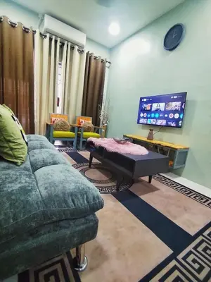 a living room with a couch and a tv at D'mesyar Homestay 3BR Fully airconds in Teluk Intan