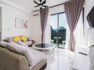 a living room with a couch and a large window at 2Br Sunway Onsen Suit 5 Pax in Tambun