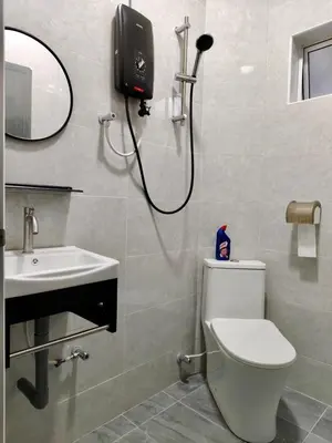 a bathroom with a shower and a toilet and a sink at Grace Homestay Taiping in Taiping
