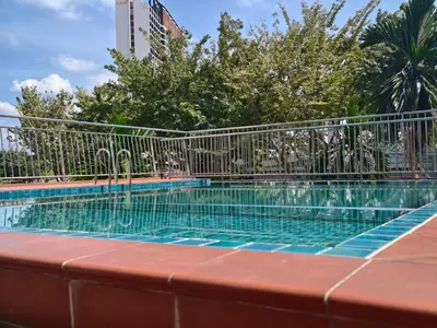 a swimming pool with a fence around it at Domuss Guesthouse- 4B3B Tunas in Bayan Lepas