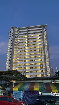 a tall building with cars parked in front of it at Domuss Guesthouse- 4B3B Tunas in Bayan Lepas