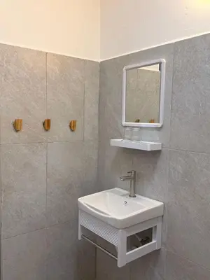 a bathroom with a sink and a mirror at Capy House Taiping in Taiping