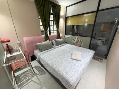 a small bedroom with a bed and a window at Capy House Taiping in Taiping