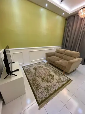 a living room with a couch and a tv at UHhomestay in Kampong Tok Bedu
