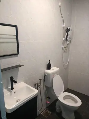 a bathroom with a white toilet and a sink at Ipoh budget house in Ipoh