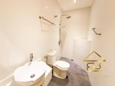 a white bathroom with a toilet and a sink at 7BR Huge House, 6 Bathroom, 20Pax, 10 min to IpohCity in Ipoh