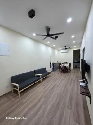 a living room with a couch and a ceiling fan at Bliss Homestay in Simpang Ampat