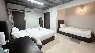 a hotel room with two beds and a couch at Gather lnn in George Town