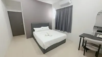 a bedroom with a white bed and a desk and a chair at Gather lnn in George Town
