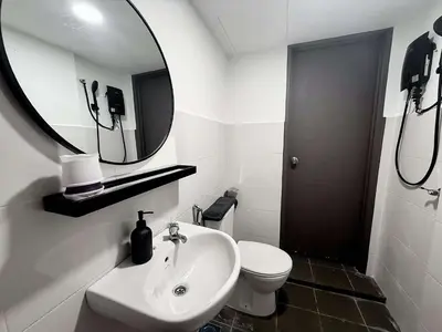 a white bathroom with a sink and a mirror at Gather lnn in George Town