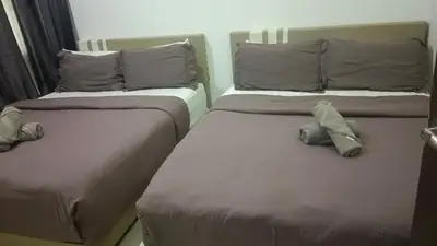 two beds sitting next to each other in a room at Skyhauz Ipoh Cityview 2BR Homestay in Ipoh