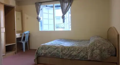 a bedroom with a bed and a window and a desk at Cameron Highland 3 Bedroom Apartment in Cameron Highlands