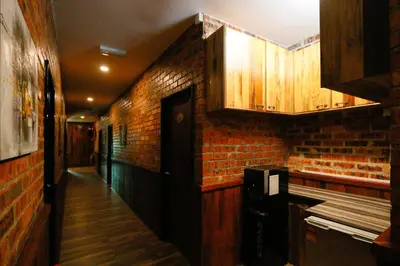 a room with a brick wall and wooden cabinets at Anggun Hotel in Seri Iskandar