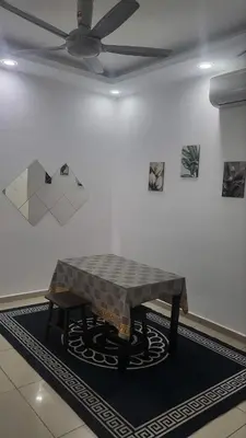 a table in a room with a ceiling fan at Homestay PPAM Dalur Apartment Presint 18,Putrajaya in Gua Sai