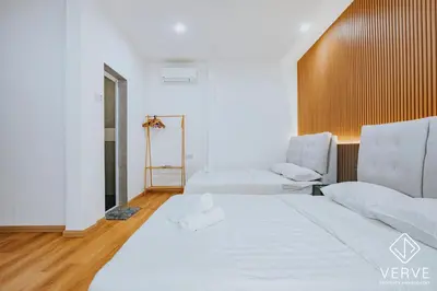 a white room with two beds and two chairs at Ipoh 55 Private Pool By Verve 26PAX in Ipoh
