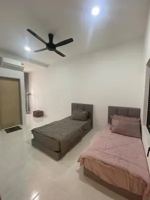 a bedroom with two beds and a ceiling fan at Cozy Homestay, Tasek Idaman Town, Batu Gajah in Batu Gajah