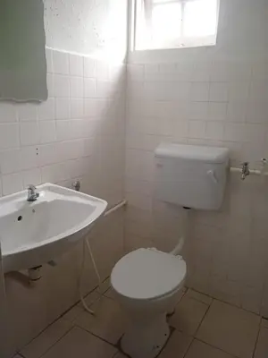 a bathroom with a white toilet and a sink at Netasha Holiday INN in Tanah Rata